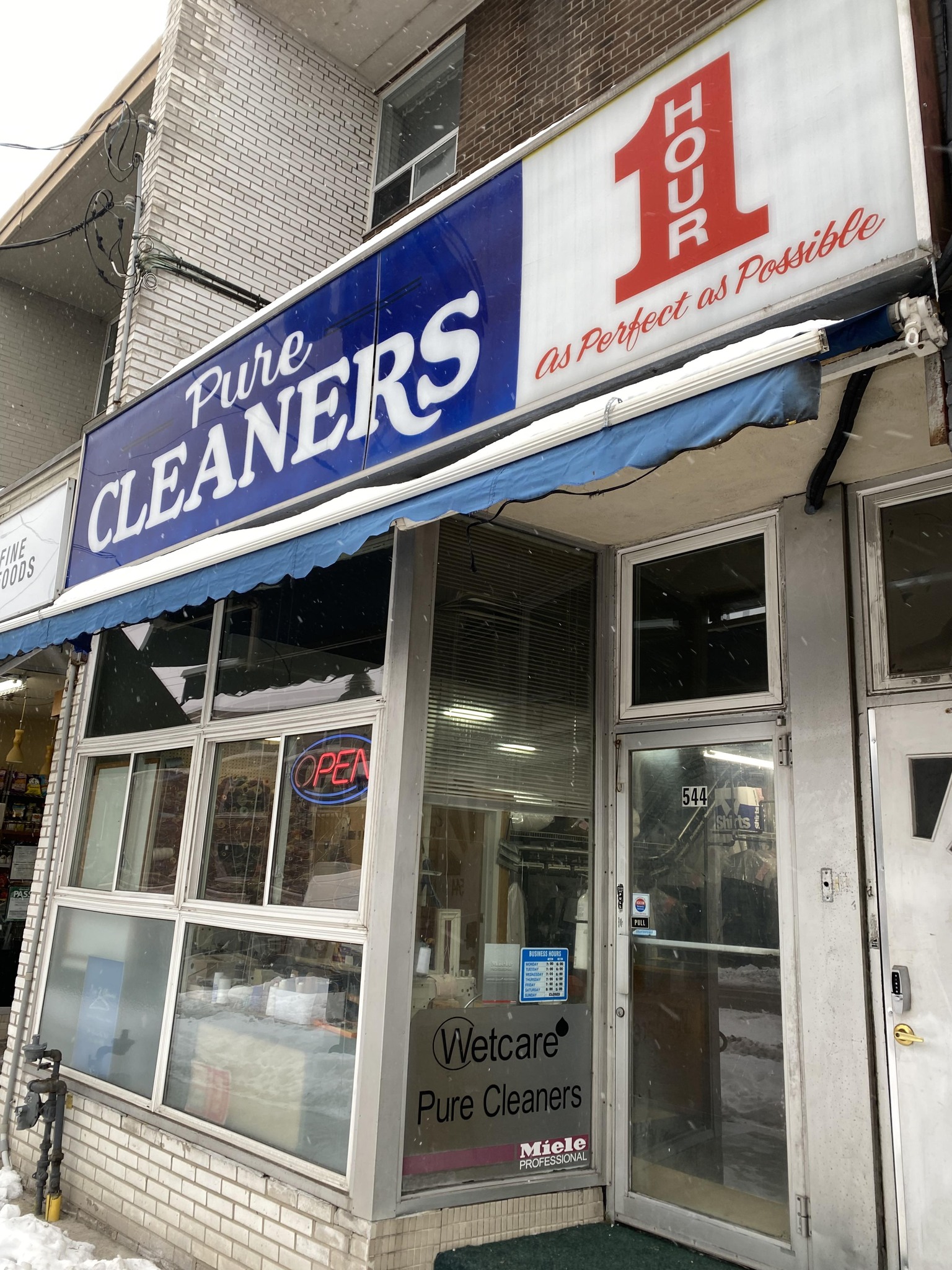 Pure Cleaners storefront at 544 Eglinton Ave W — OPEN sign and 1 Hour service signage
