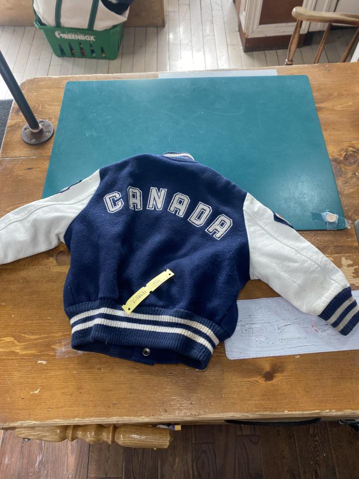 Varsity jacket restoration in progress on the Pure Cleaners workbench